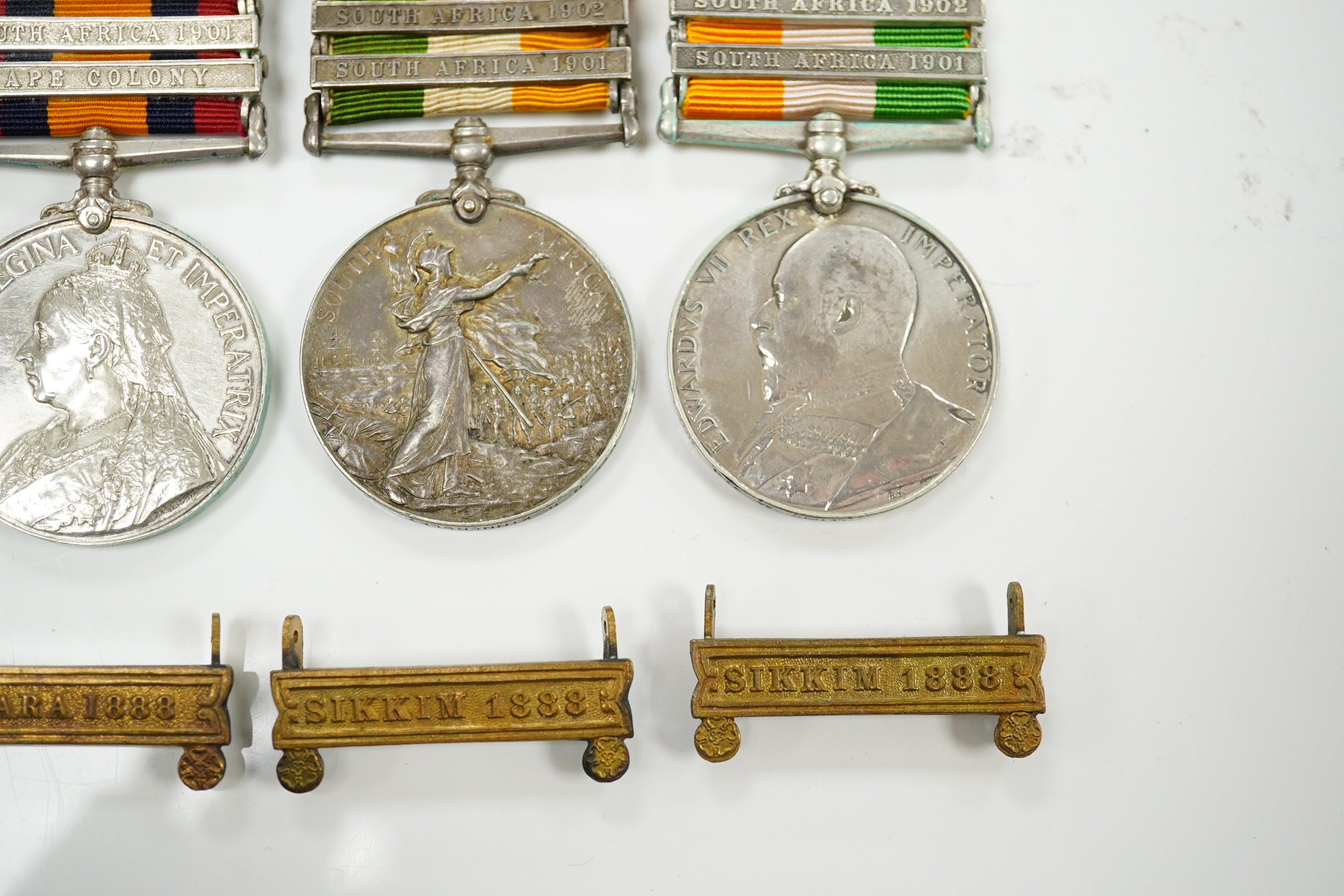 A Queen's South Africa Medal with Laings Nek, Belfast and OFS clasps to 12036 Bomr M.Miller R.F.A.Arty, another unnamed with 1901, 1902 and CC clasps, and two King's South Africa medals both with 1901/1902 clasps to 6408